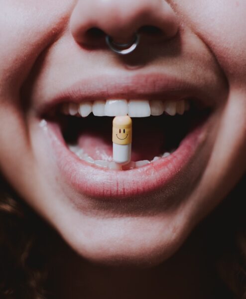 a woman with an mdma pill in her mouth | Las Vegas Center for Psychedelic Therapy